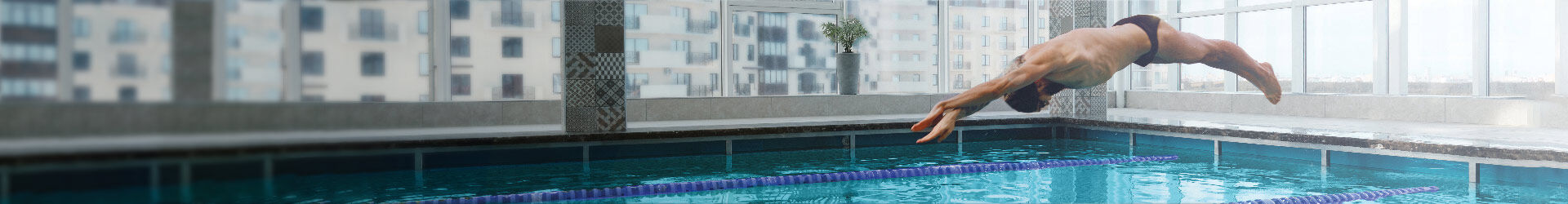Man divng into an indoor pool